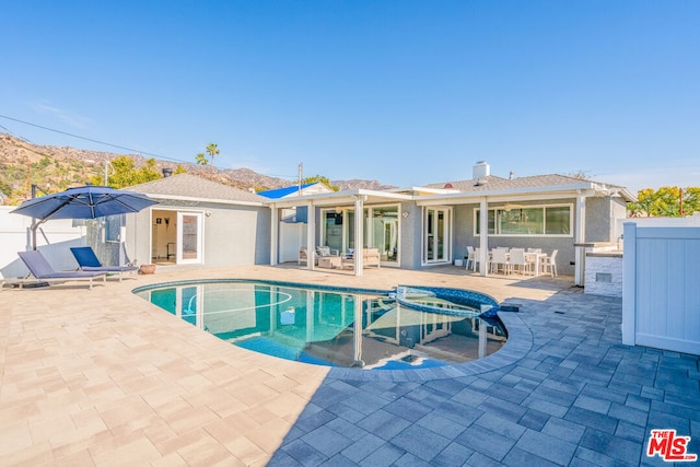 view of swimming pool featuring a mountain view and a patio area