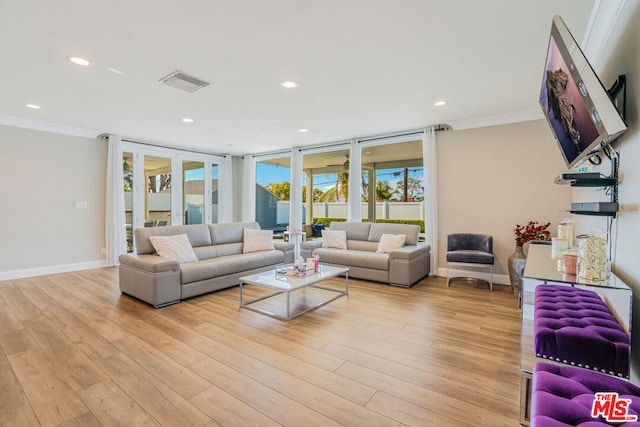 living room featuring crown molding, floor to ceiling windows, french doors, and light wood-type flooring