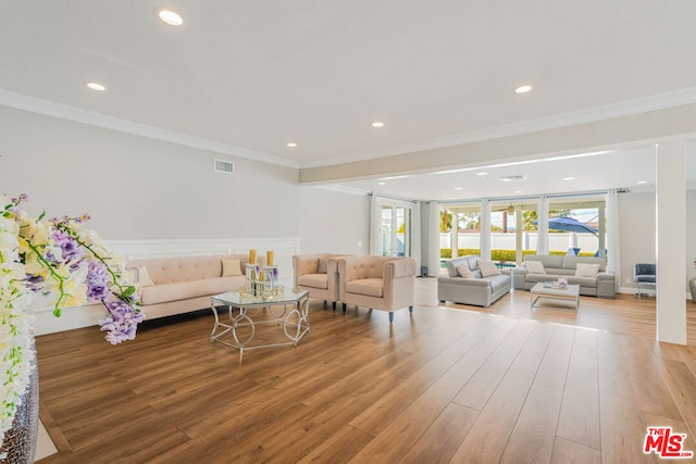 living room with ornamental molding and light wood-type flooring