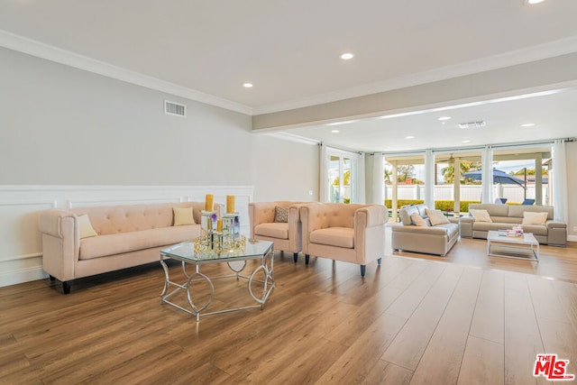 living room with hardwood / wood-style floors and ornamental molding