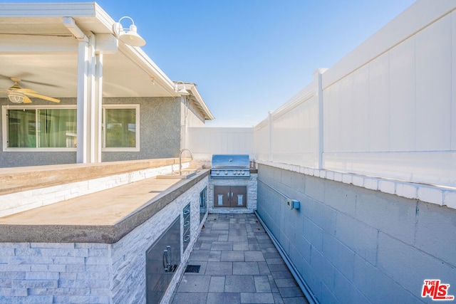 view of patio featuring a grill, sink, and exterior kitchen