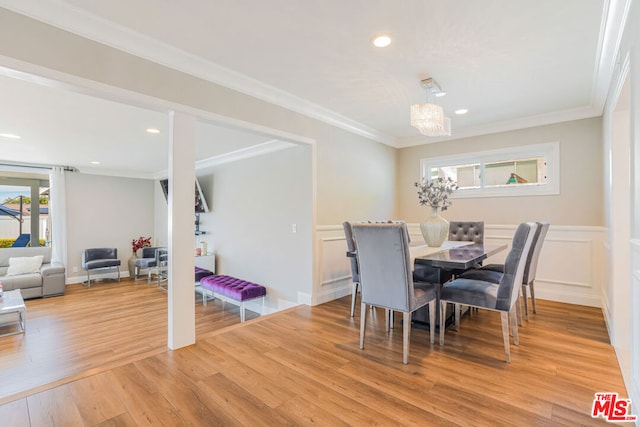 dining area with ornamental molding and hardwood / wood-style floors