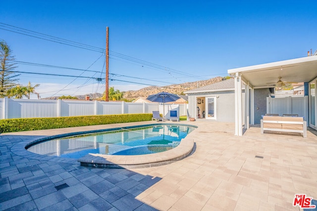 view of pool with a patio and ceiling fan