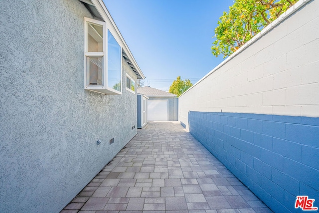 view of patio featuring a garage and an outdoor structure