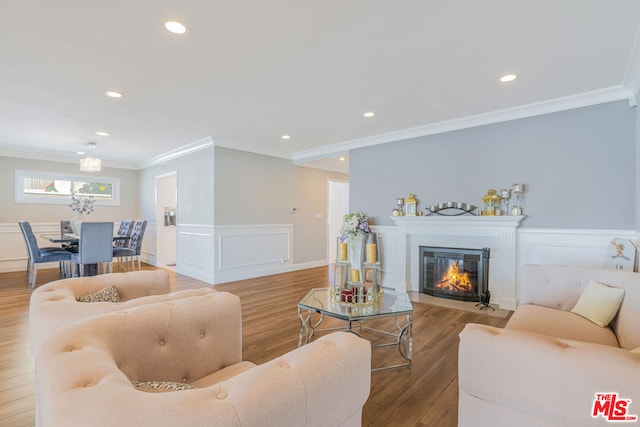 living room with crown molding and hardwood / wood-style floors