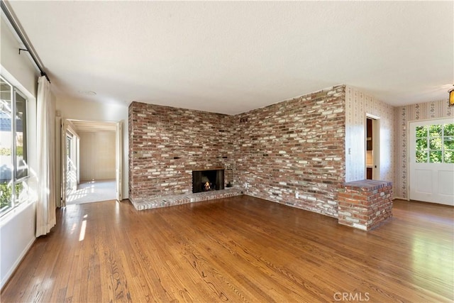 unfurnished living room with a fireplace and hardwood / wood-style floors