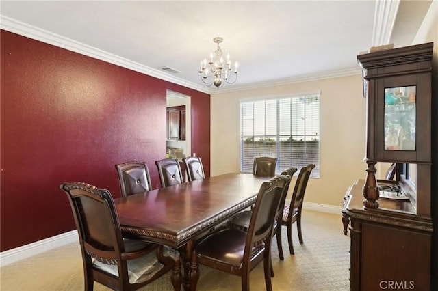 dining room with ornamental molding, light colored carpet, and a chandelier