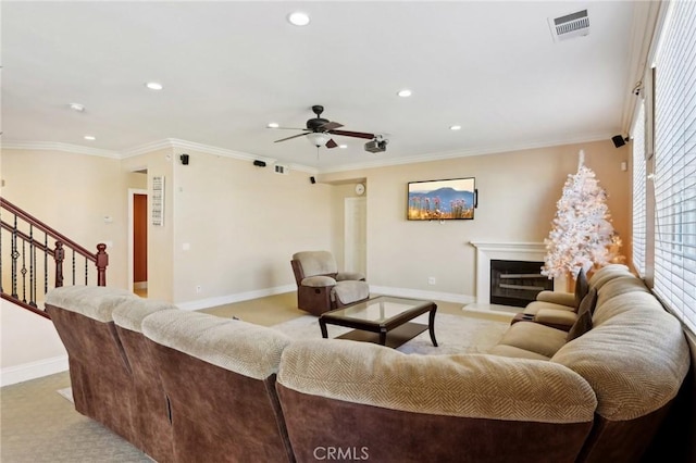 living room with light carpet, crown molding, and ceiling fan