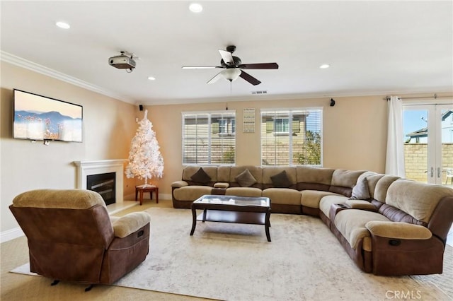 living room featuring ornamental molding and ceiling fan