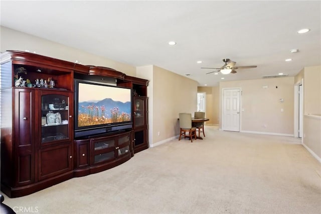 living room with light colored carpet and ceiling fan