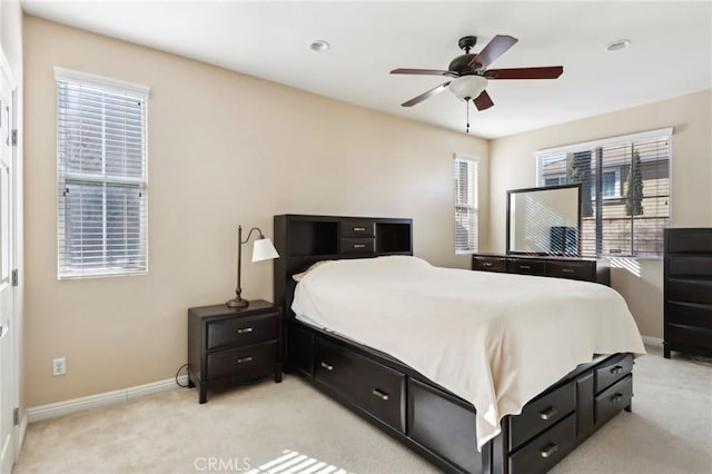 bedroom featuring light carpet and ceiling fan