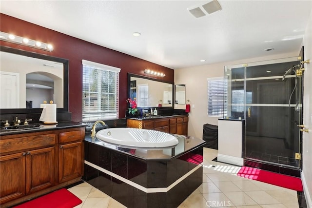 bathroom featuring vanity, independent shower and bath, and tile patterned flooring