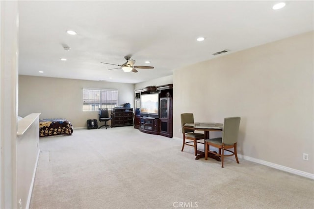 interior space featuring light carpet and ceiling fan