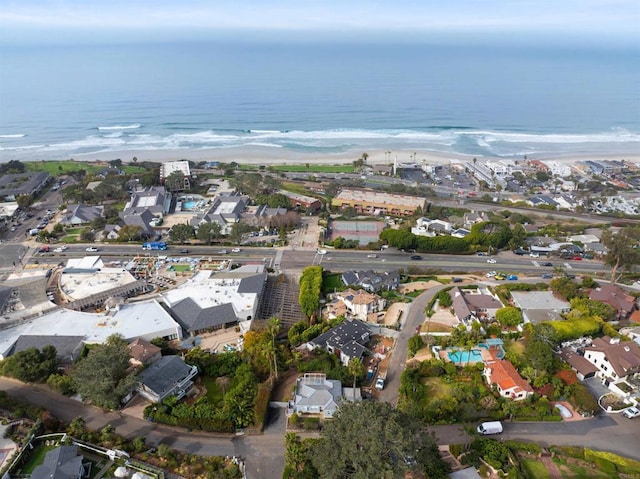 birds eye view of property with a beach view and a water view