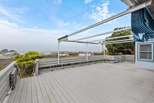 wooden terrace featuring a pergola and a water view