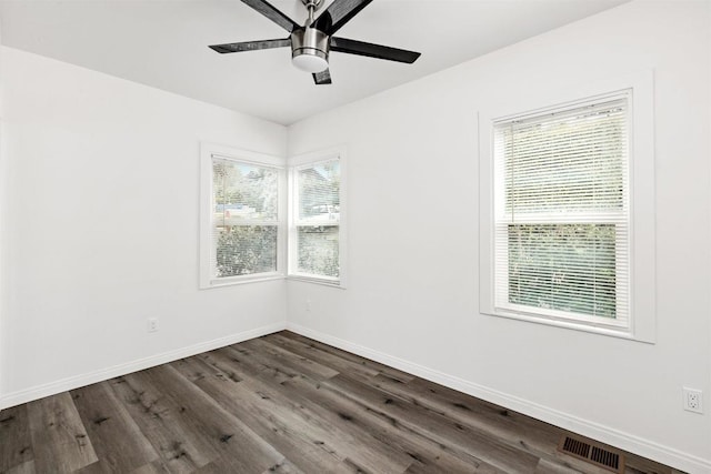 empty room with ceiling fan and dark hardwood / wood-style flooring