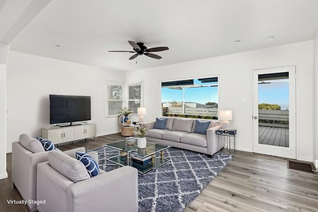 living room featuring dark hardwood / wood-style floors and ceiling fan