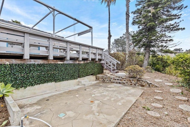 view of patio featuring stairway and a wooden deck