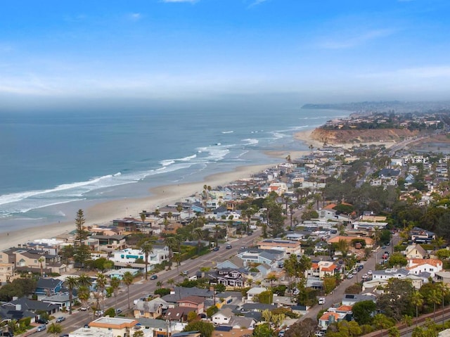 aerial view with a residential view, a view of the beach, and a water view