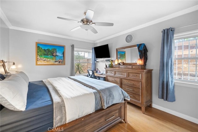 bedroom featuring crown molding, light hardwood / wood-style flooring, and ceiling fan