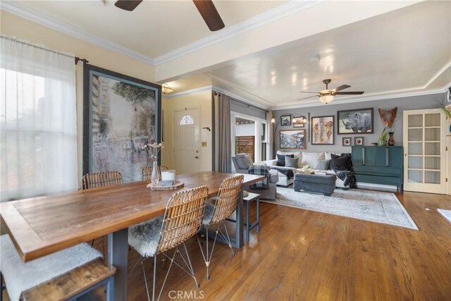 dining room with hardwood / wood-style flooring, ceiling fan, and crown molding