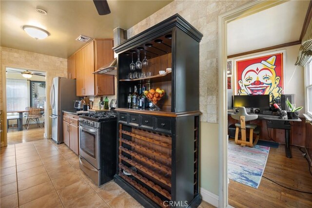 kitchen featuring light tile patterned floors, stainless steel appliances, and ceiling fan