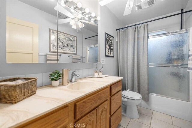 full bathroom featuring shower / bath combination with curtain, ceiling fan, tile patterned floors, and toilet