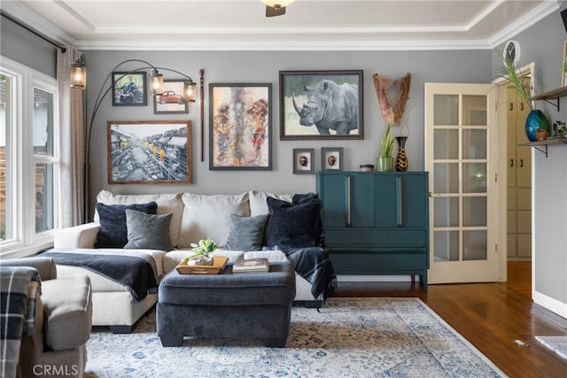 living area with crown molding and dark hardwood / wood-style floors