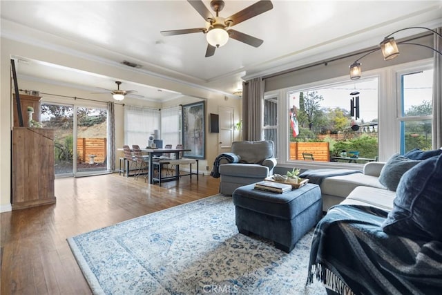 living room with ceiling fan, ornamental molding, and hardwood / wood-style floors