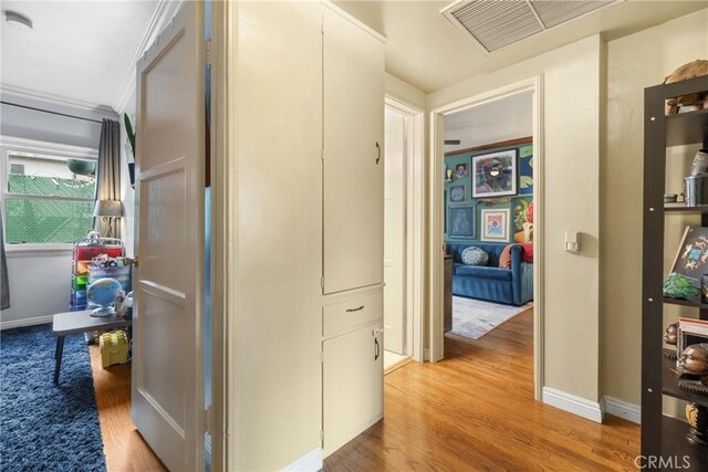 corridor with light hardwood / wood-style flooring