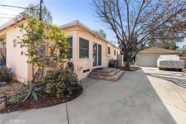 view of front of property with a garage and an outdoor structure