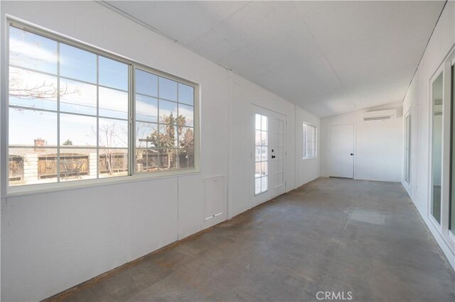 56766 Golden Bee Dr, Yucca Valley, CA 92284 - empty room with an AC wall unit and unfinished concrete floors