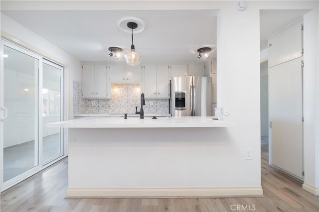 56766 Golden Bee Dr, Yucca Valley, CA 92284 - kitchen featuring stainless steel fridge, a sink, decorative backsplash, light countertops, and light wood-style flooring