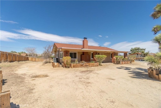 56766 Golden Bee Dr, Yucca Valley, CA 92284 - rear view of property with fence and a chimney