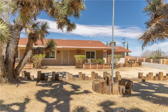 56766 Golden Bee Dr, Yucca Valley, CA 92284 - back of house featuring fence and stucco siding