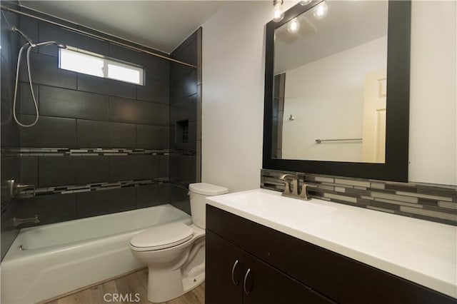 56766 Golden Bee Dr, Yucca Valley, CA 92284 - full bathroom with wood finished floors, toilet, backsplash, bathtub / shower combination, and vanity