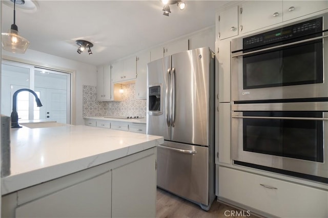 56766 Golden Bee Dr, Yucca Valley, CA 92284 - kitchen featuring stainless steel appliances, tasteful backsplash, white cabinets, and a sink