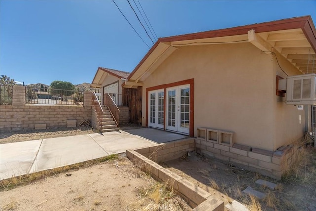 56766 Golden Bee Dr, Yucca Valley, CA 92284 - view of home's exterior featuring french doors, fence, stucco siding, and a patio area