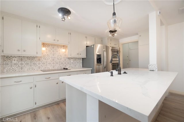 56766 Golden Bee Dr, Yucca Valley, CA 92284 - kitchen featuring black electric cooktop, stainless steel fridge, light wood-style flooring, tasteful backsplash, and a sink