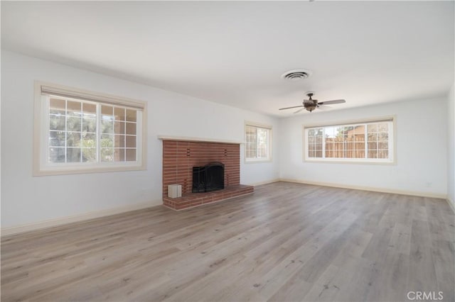 56766 Golden Bee Dr, Yucca Valley, CA 92284 - unfurnished living room with wood finished floors, baseboards, and a fireplace