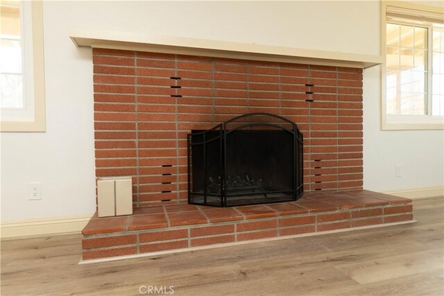 56766 Golden Bee Dr, Yucca Valley, CA 92284 - detailed view of wood finished floors, a fireplace, and baseboards