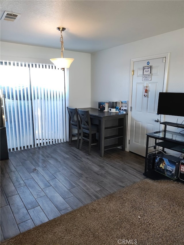 interior space featuring dark wood-type flooring and visible vents