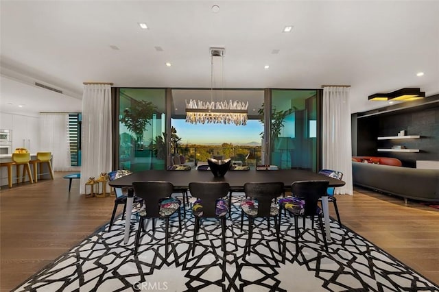 dining area with floor to ceiling windows, hardwood / wood-style floors, and a chandelier