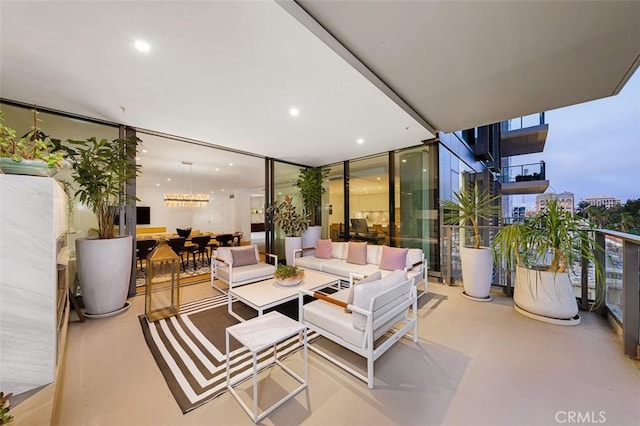 interior space with a wall of windows, concrete flooring, and recessed lighting