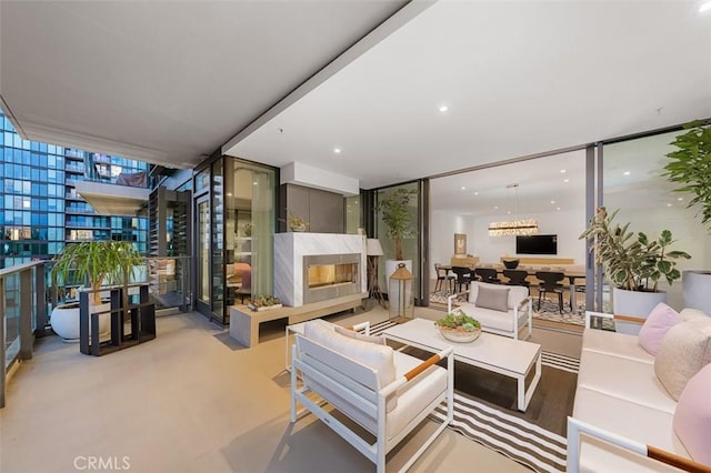 living room featuring expansive windows and a high end fireplace