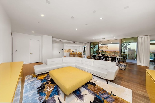 living area with recessed lighting and wood finished floors