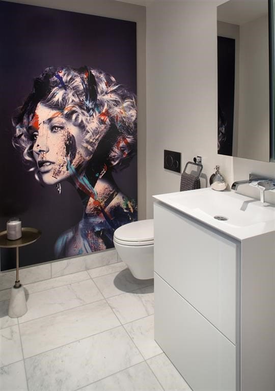 bathroom with toilet, vanity, and marble finish floor