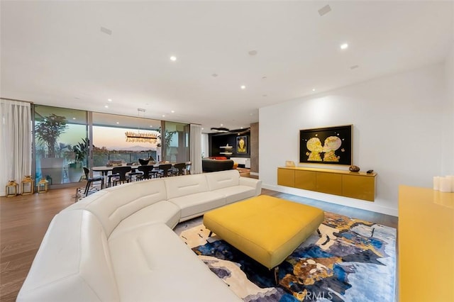 living room with recessed lighting, baseboards, and wood finished floors