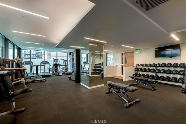 gym featuring visible vents and expansive windows