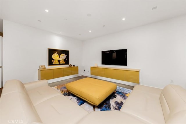 living area with wood finished floors and recessed lighting